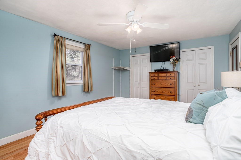 155 Groton Road Shirley, MA 01464 - Photo 17 of 42 a bedroom with a bed dresser and flat screen tv