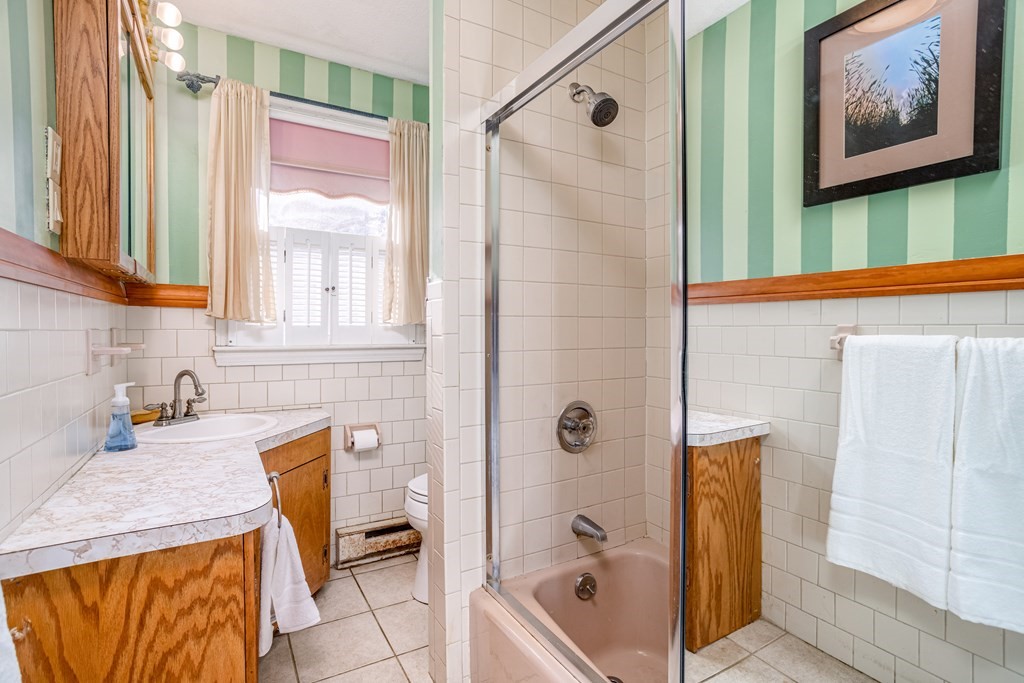 155 Groton Road Shirley, MA 01464 - Photo 18 of 42 a bathroom with a granite countertop sink and a bathtub with shower
