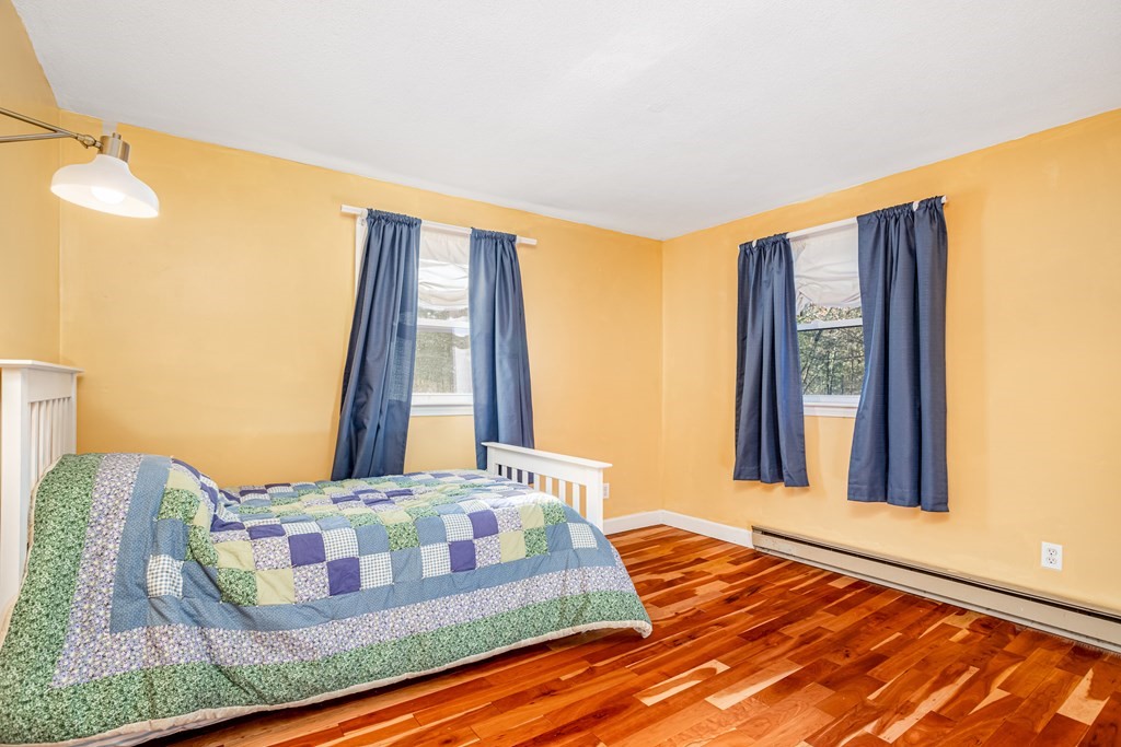 155 Groton Road Shirley, MA 01464 - Photo 20 of 42 a bedroom with a bed and wooden floor
