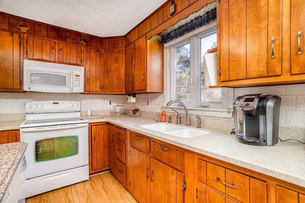 155 Groton Road Shirley, MA 01464 - Photo 7 of 42 a kitchen with stainless steel appliances granite countertop a sink stove and cabinets