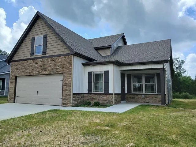 a view of a house with backyard porch and garden