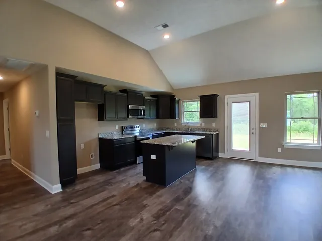 an empty room with a window and a ceiling fan