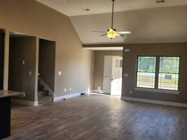 a living room with couches and wooden floor