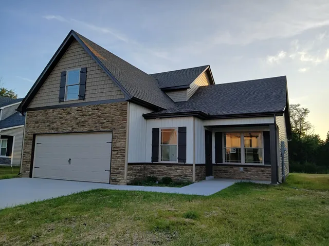 a front view of a house with a yard and garage