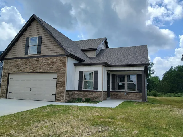 a kitchen with stainless steel appliances granite countertop a stove top oven a sink dishwasher and a refrigerator with wooden floor