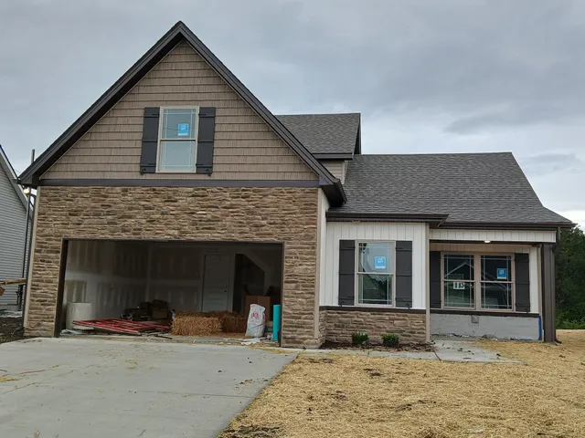 a view of a swimming pool with a yard and large trees