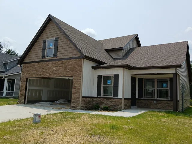 a large kitchen with stainless steel appliances granite countertop a refrigerator and a stove