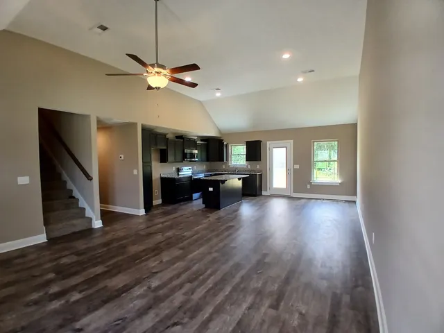 a bathroom with a sink a toilet a mirror and shower