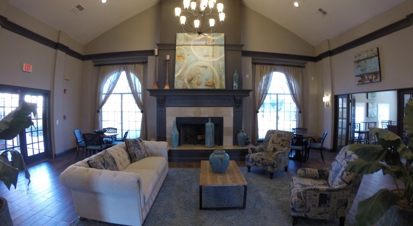 3102 Bay Area Boulevard, Unit 212 Friendswood, TX 77546 - Photo 2 of 15 a living room with furniture a fireplace and a large window