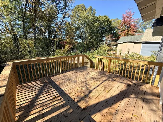 a view of balcony with wooden floor and fence