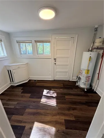 a view of room with window and wooden floor