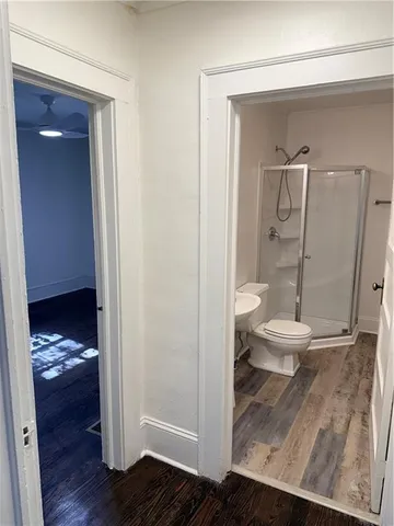 a bathroom with a granite countertop toilet and a sink