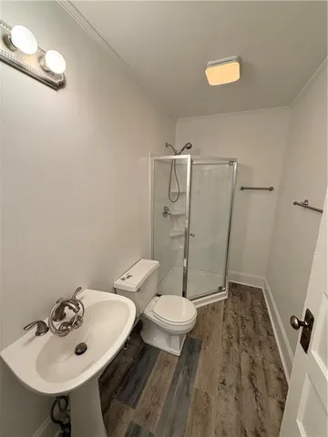 a bathroom with a sink toilet and a mirror