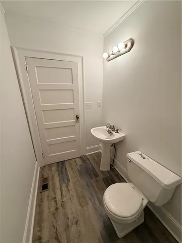 a bathroom with a toilet a sink and a mirror