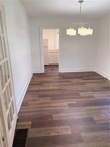 a view of a room with wooden floor and staircase