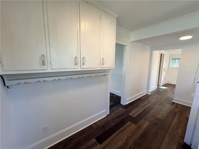 a view of storage and utility room with wooden floor