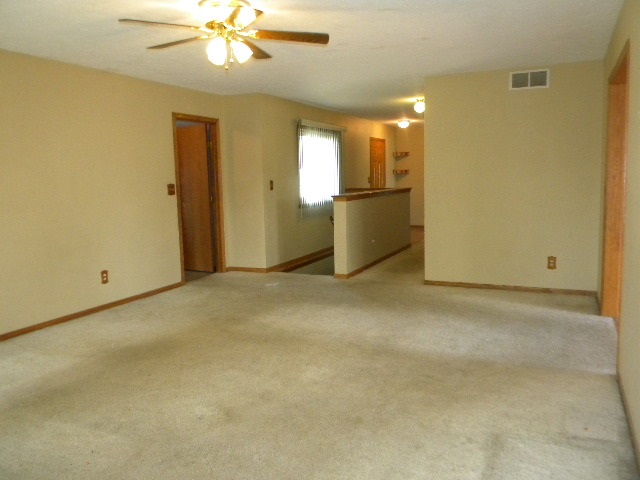 617 Pin Oak Road Rockton, IL 61072 - Photo 3 of 25 a view of a livingroom with a chandelier fan and kitchen view