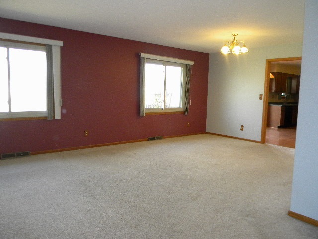 617 Pin Oak Road Rockton, IL 61072 - Photo 6 of 25 an empty room with windows and chandelier fan