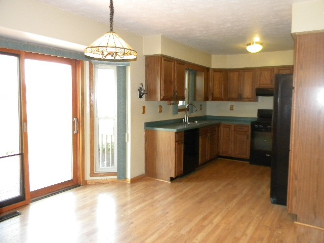 617 Pin Oak Road Rockton, IL 61072 - Photo 9 of 25 a kitchen with stainless steel appliances granite countertop a stove a sink and a refrigerator