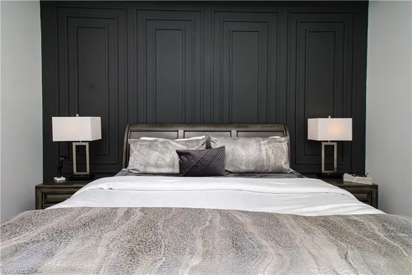 a bedroom with a bed and a lamp on table