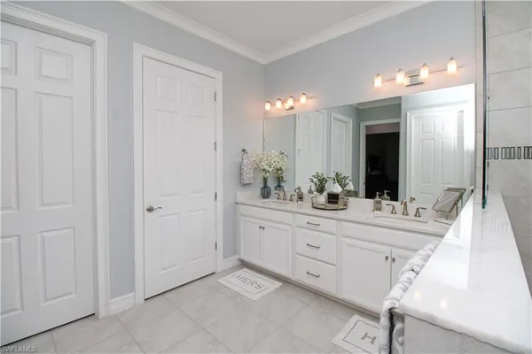 a spacious bathroom with a double vanity sink and a mirror