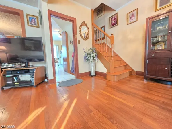 a view of a hallway with entryway wooden floor and front door