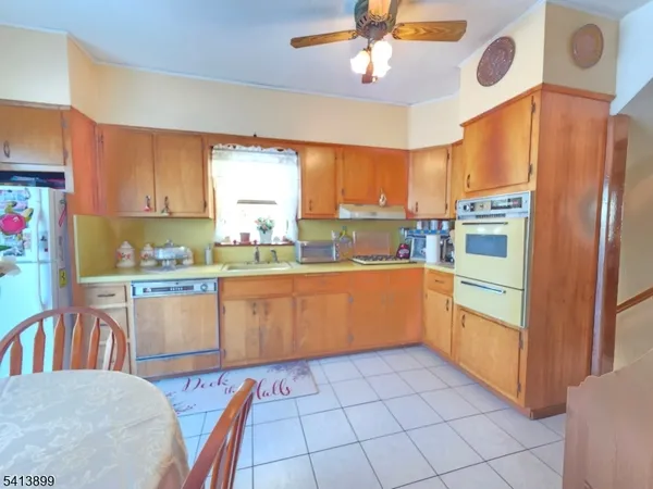 a kitchen with stainless steel appliances granite countertop a refrigerator a sink a stove and island