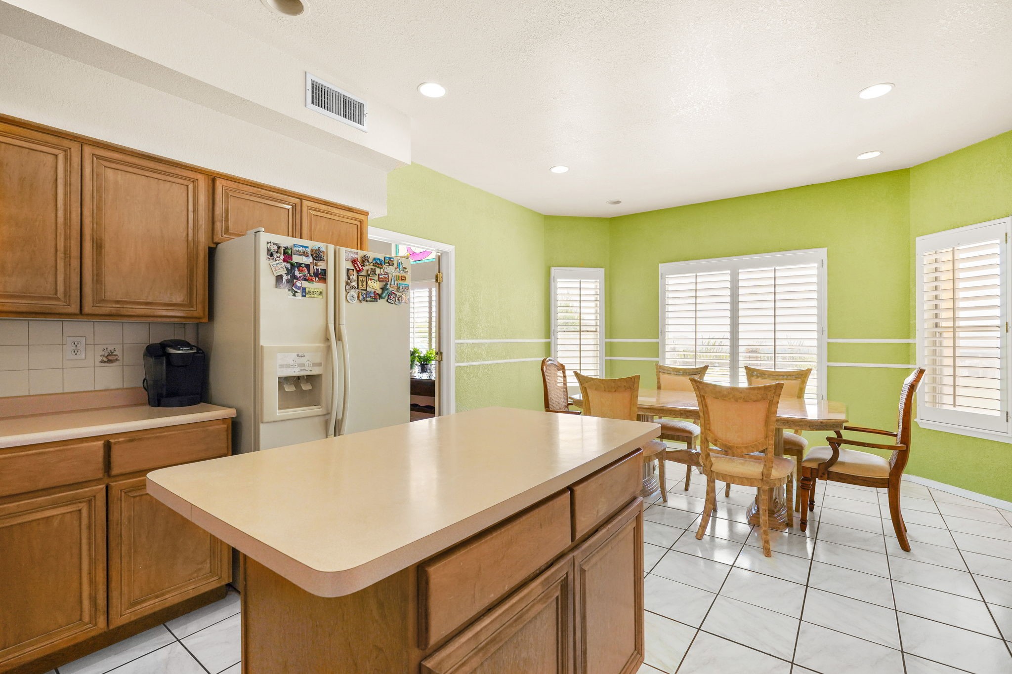 6574 Eagle Ridge Drive El Paso, TX 79912 - Photo 20 of 50 a kitchen with stainless steel appliances kitchen island granite countertop a table chairs and a refrigerator