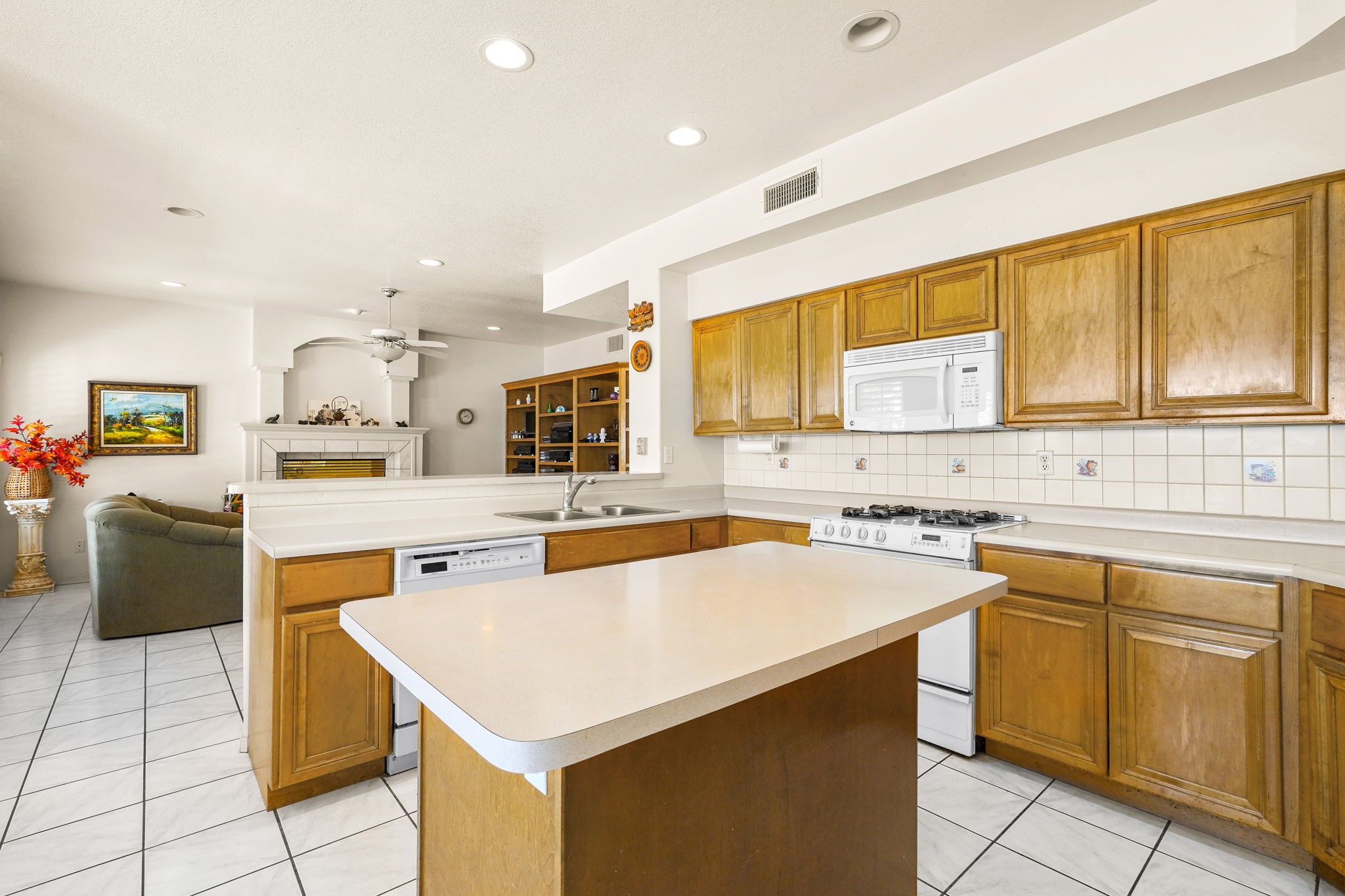 6574 Eagle Ridge Drive El Paso, TX 79912 - Photo 21 of 50 a kitchen with a sink a stove and chairs