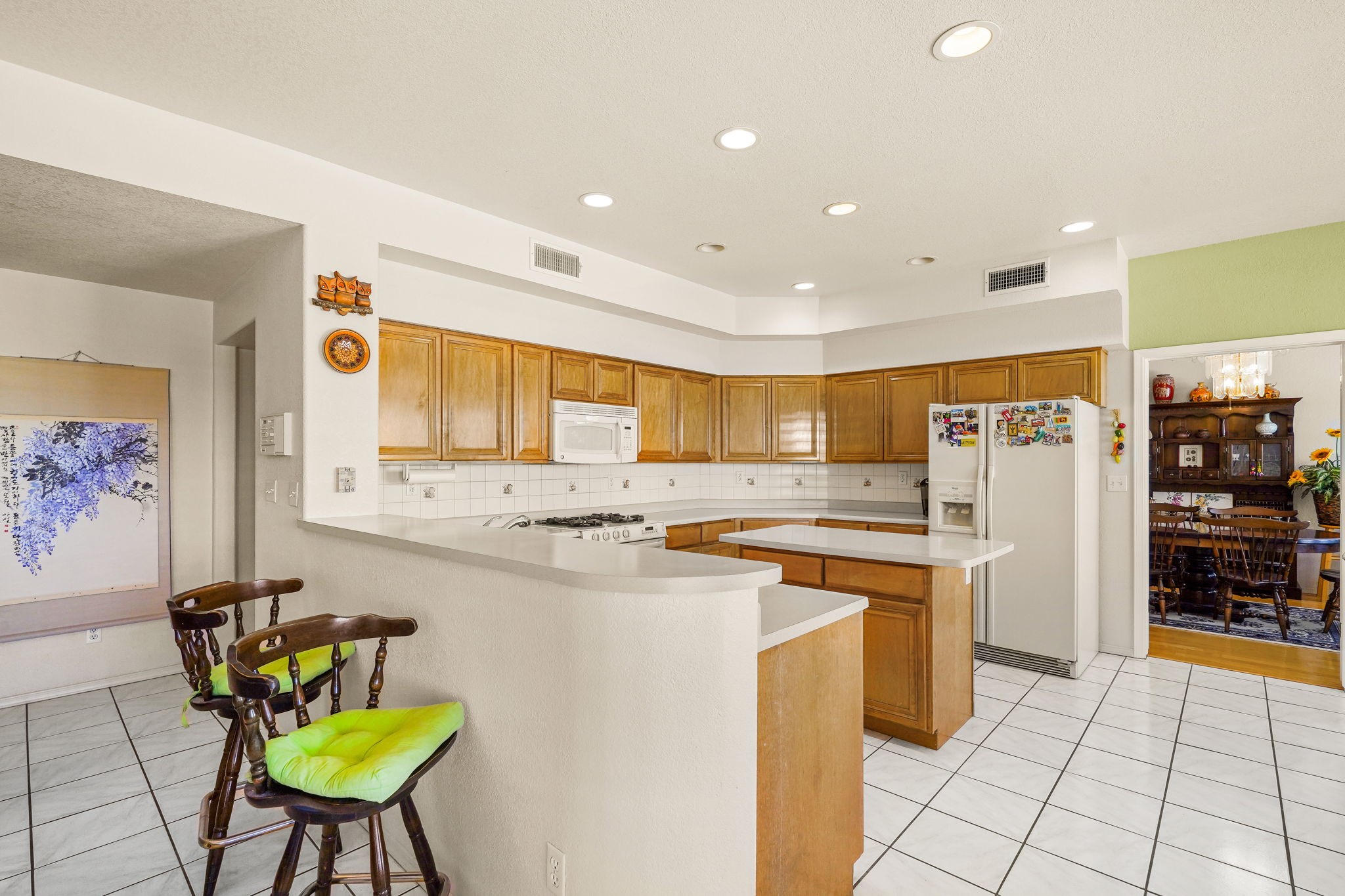 6574 Eagle Ridge Drive El Paso, TX 79912 - Photo 23 of 50 a kitchen with stainless steel appliances a stove a refrigerator a dining table and chairs
