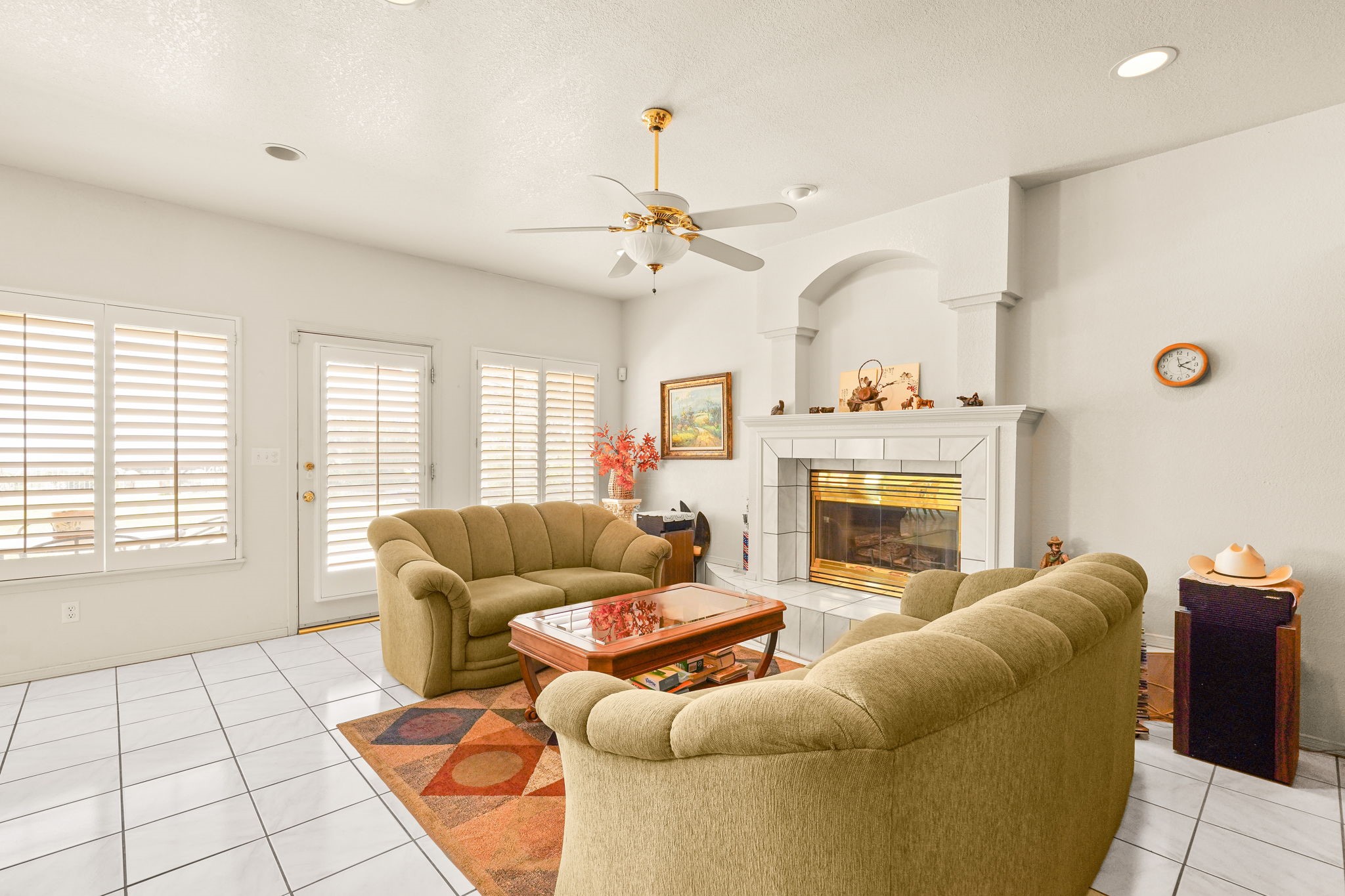 6574 Eagle Ridge Drive El Paso, TX 79912 - Photo 26 of 50 a living room with furniture a fireplace and a flat screen tv