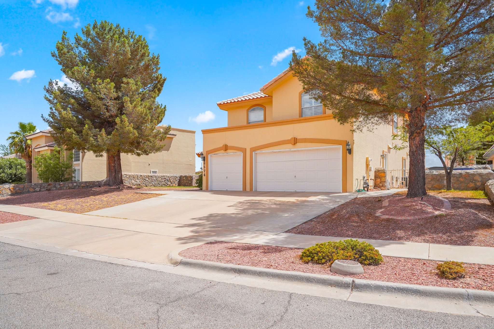 6574 Eagle Ridge Drive El Paso, TX 79912 - Photo 3 of 50 a front view of a house with a yard and garage