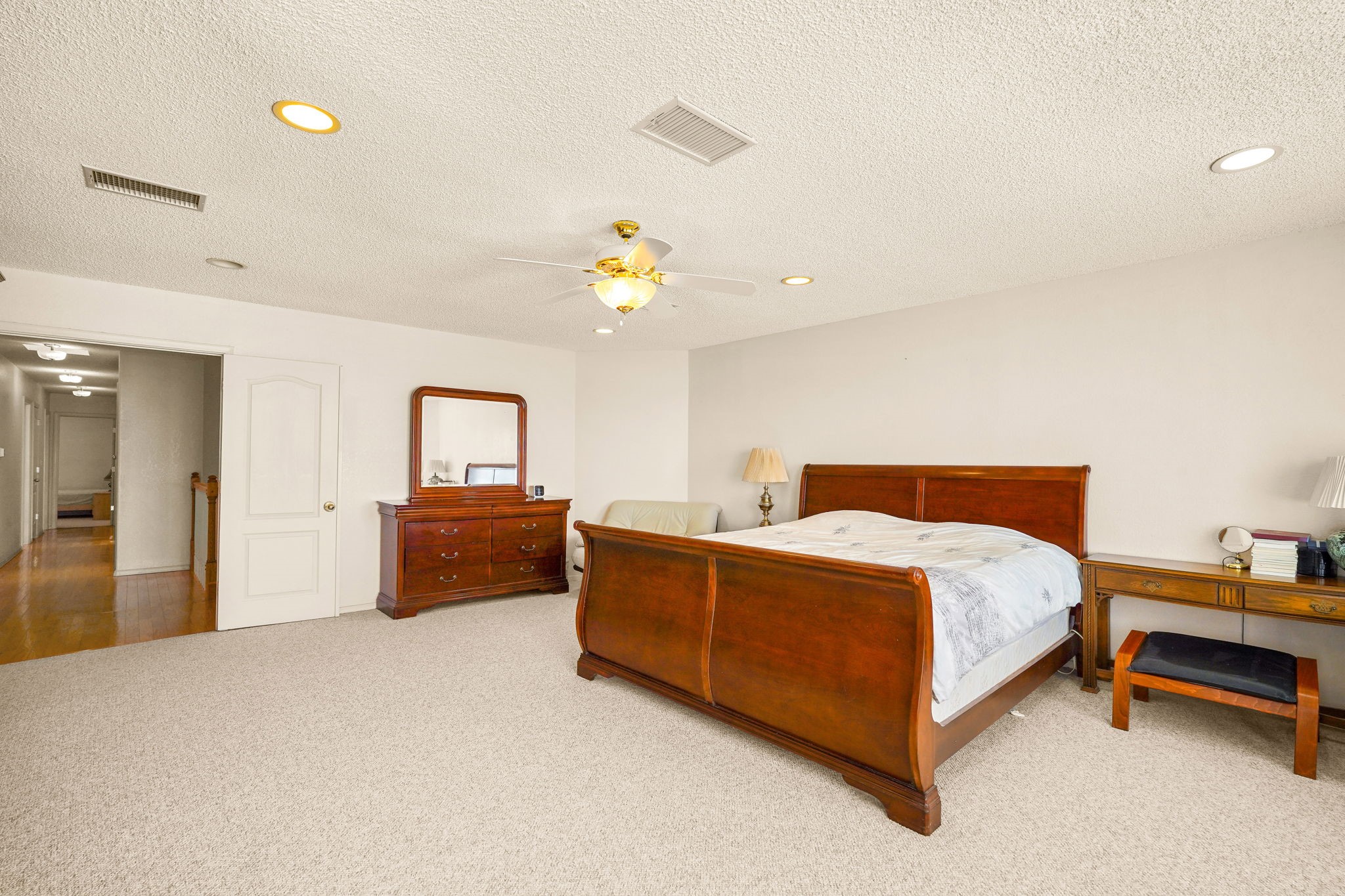 6574 Eagle Ridge Drive El Paso, TX 79912 - Photo 33 of 50 a spacious bedroom with a bed and a chandelier