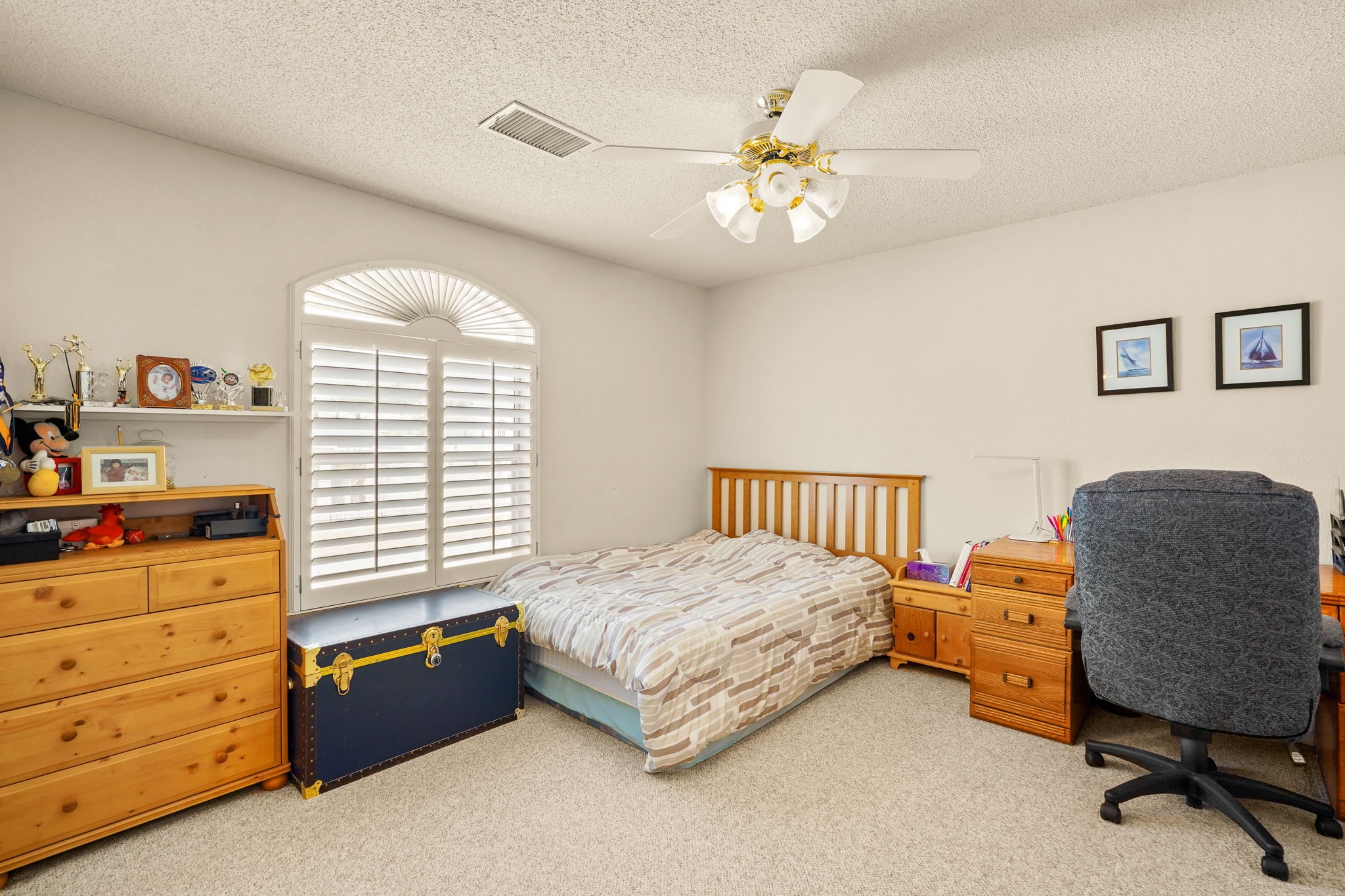 6574 Eagle Ridge Drive El Paso, TX 79912 - Photo 42 of 50 a bedroom with a bed and a chandelier