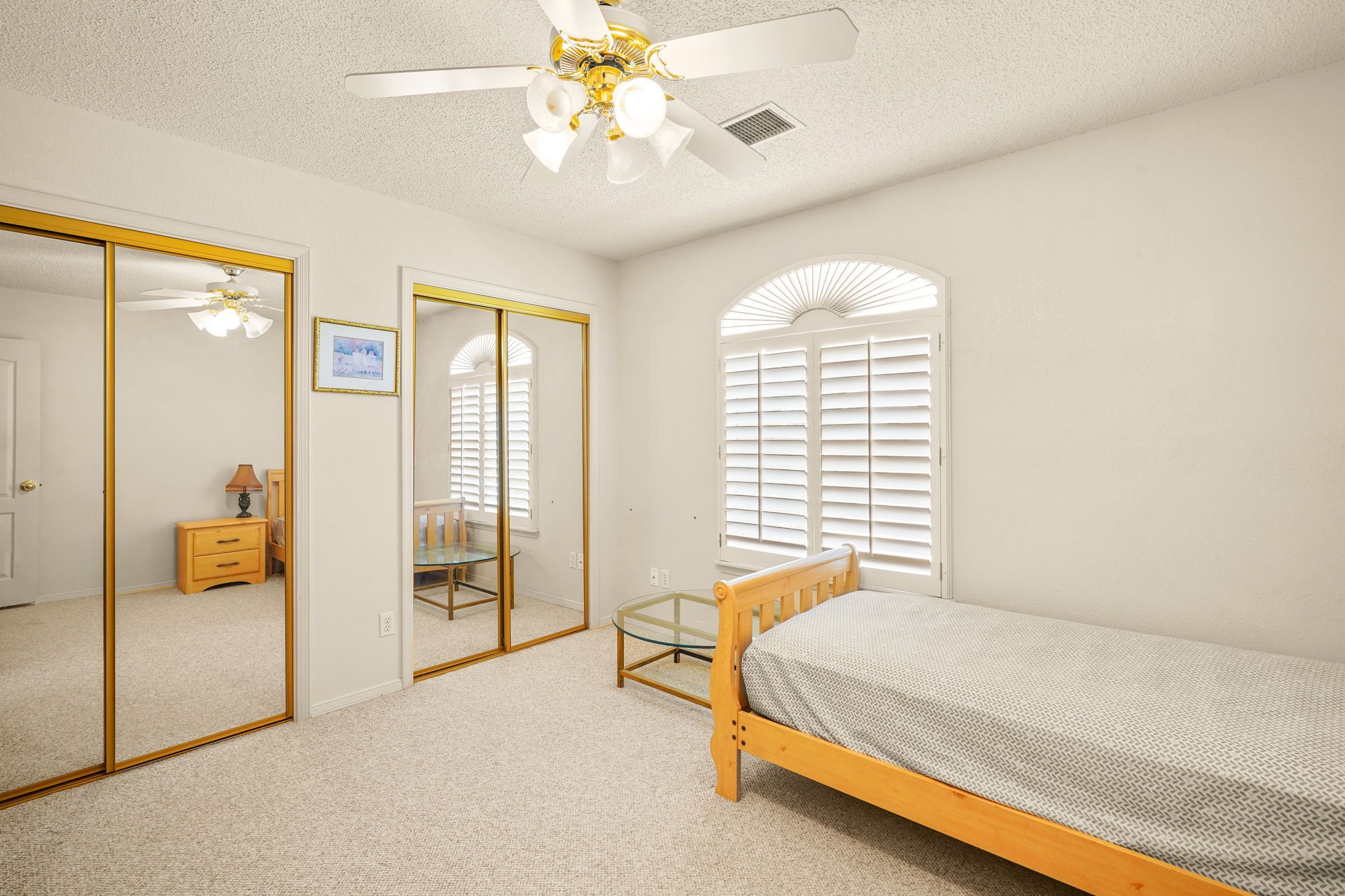 6574 Eagle Ridge Drive El Paso, TX 79912 - Photo 44 of 50 a spacious bedroom with a bed and a chandelier