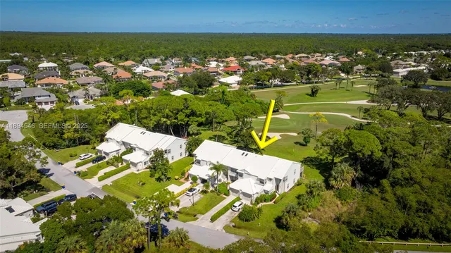 an aerial view of a residential houses with outdoor space