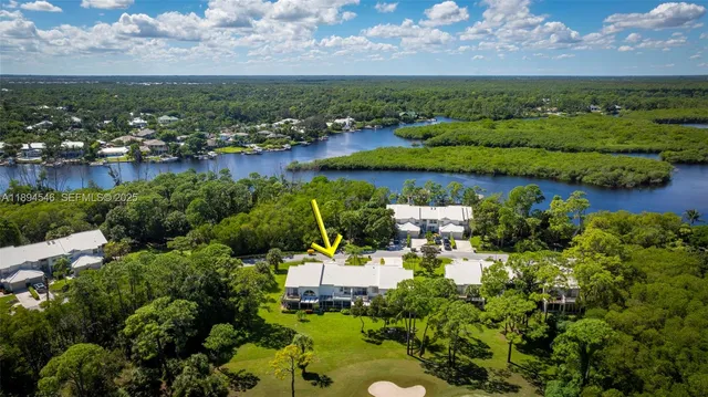 an aerial view of a houses with a lake view