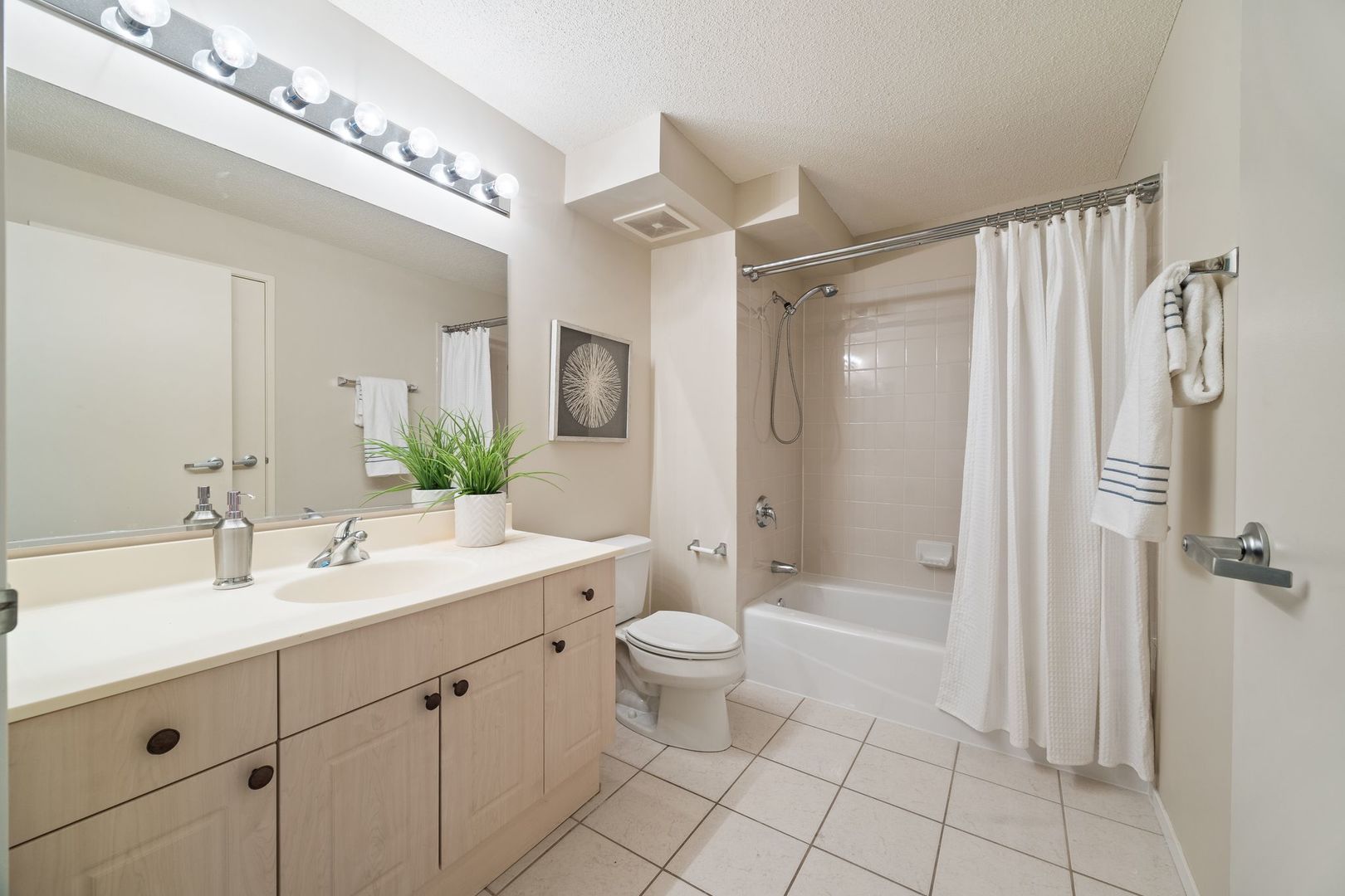 800 Elgin Road, Unit 1218 Evanston, IL 60201 - Photo 14 of 26 a spacious bathroom with a double vanity sink mirror and toilet