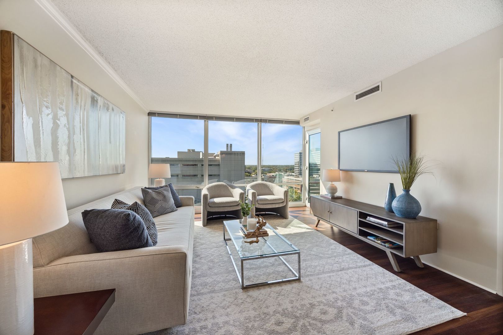 800 Elgin Road, Unit 1218 Evanston, IL 60201 - Photo 3 of 26 a living room with furniture and a flat screen tv