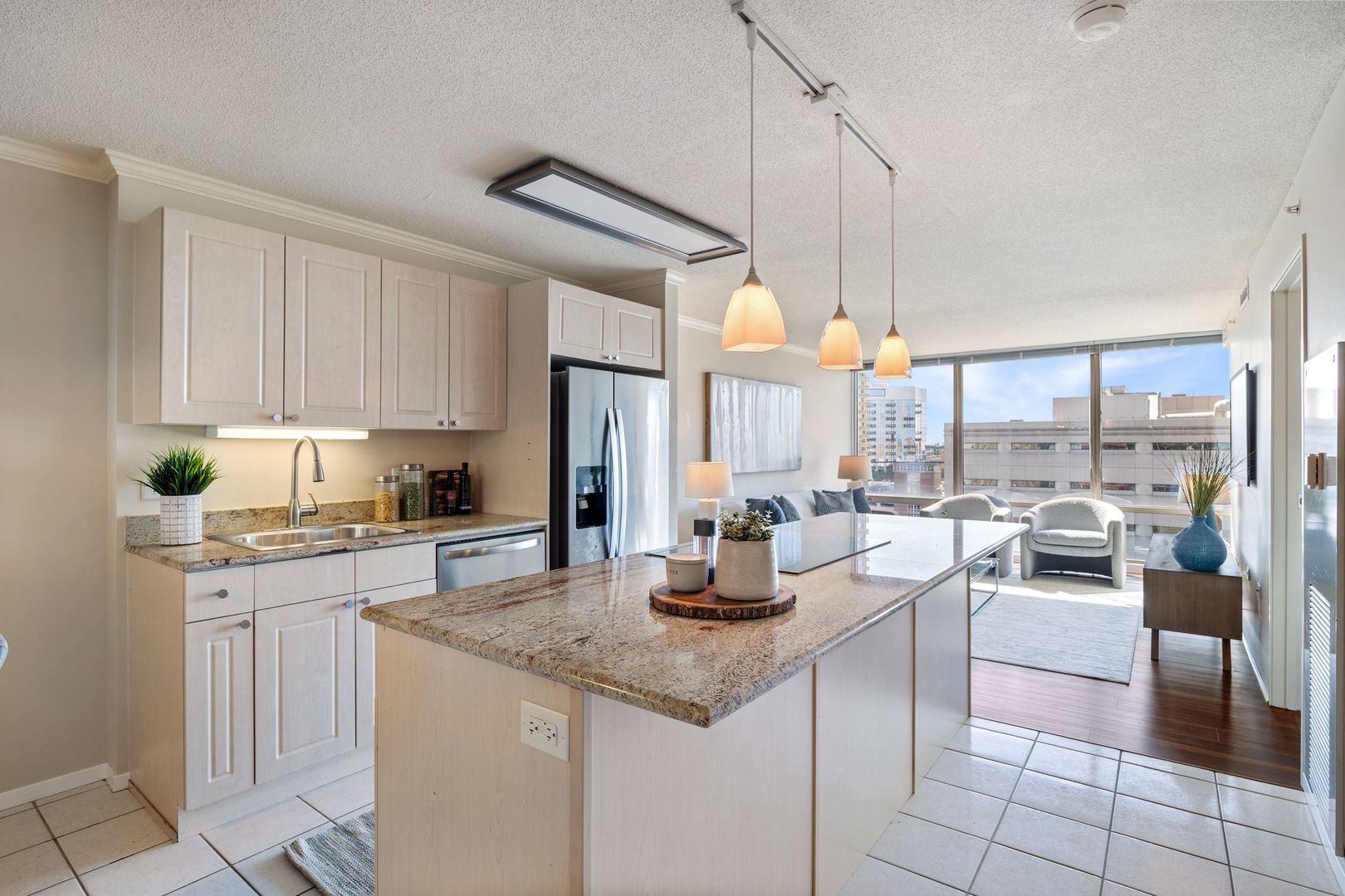 800 Elgin Road, Unit 1218 Evanston, IL 60201 - Photo 7 of 26 a kitchen with stainless steel appliances kitchen island granite countertop a table chairs sink and cabinets