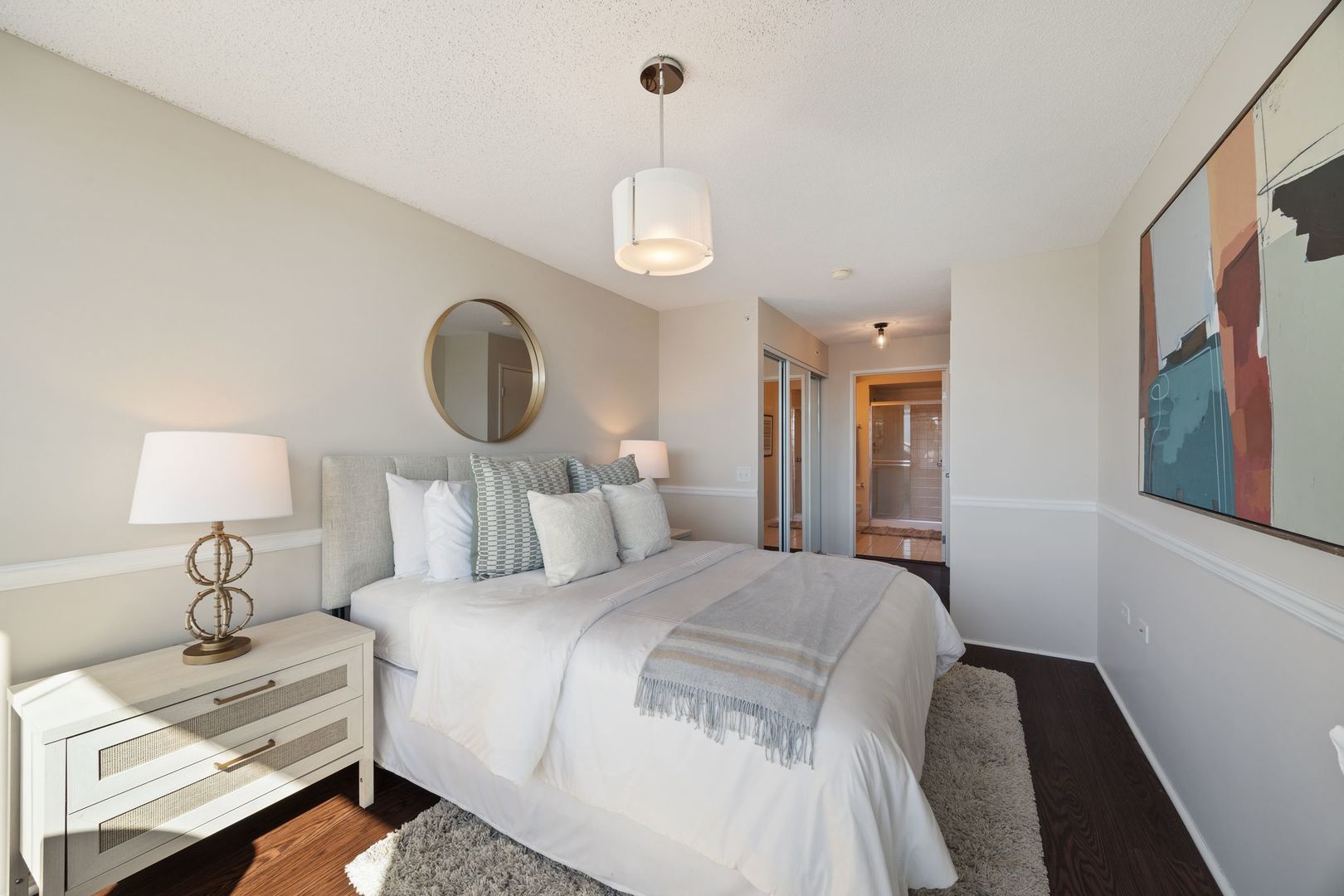 800 Elgin Road, Unit 1218 Evanston, IL 60201 - Photo 9 of 26 a bedroom with a bed and a lamp on dresser
