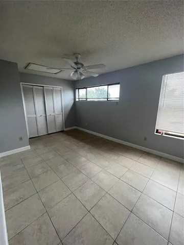 a bathroom with a granite countertop sink toilet a large mirror a shower and a bathtub