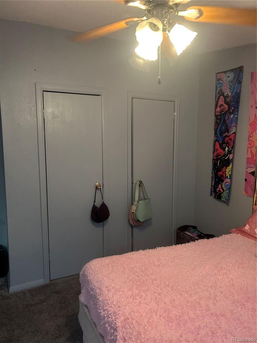 3500 35th Avenue Greeley, CO 80634 - Photo 5 of 7 a bedroom with a bed and a chandelier