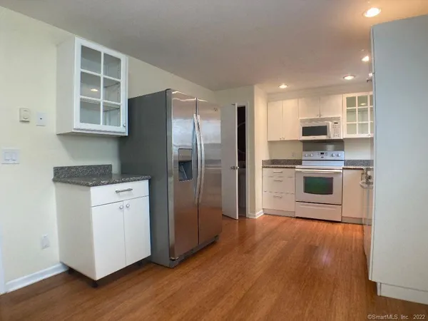 a kitchen with stainless steel appliances a refrigerator and a stove top oven