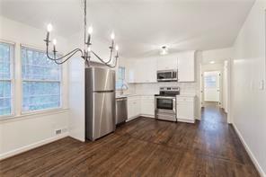 4332 Rob Roy Lane Conley, GA 30288 - Photo 8 of 21 a kitchen with granite countertop stainless steel appliances a refrigerator and a wooden floor