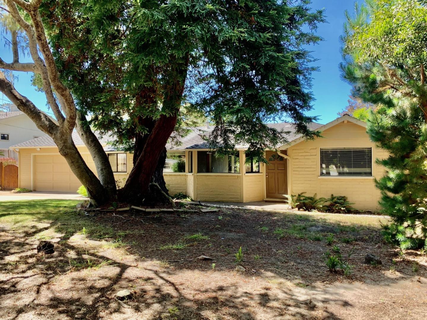 1012 San Carlos Road Pebble Beach, CA 93953 - Photo 1 of 20 a front view of a house with a yard
