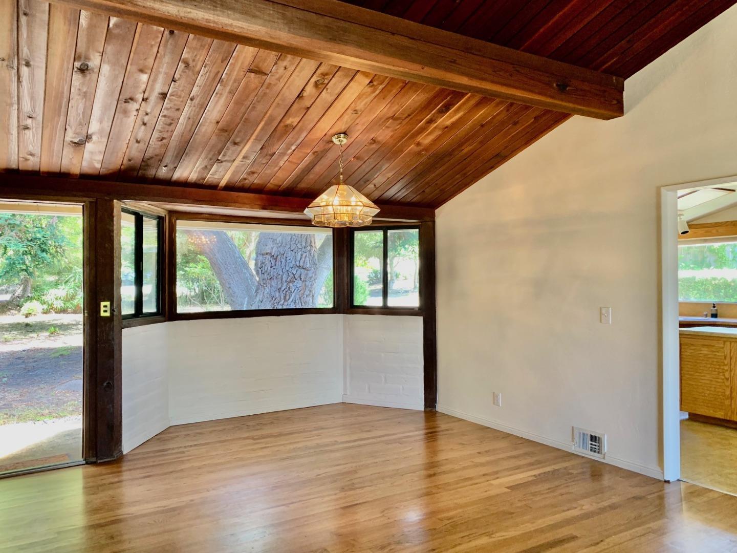 1012 San Carlos Road Pebble Beach, CA 93953 - Photo 5 of 20 a view of an empty room with wooden floor and a window