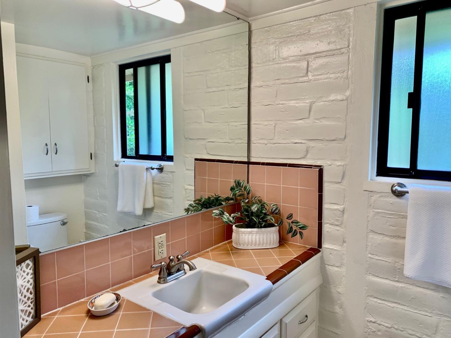 1012 San Carlos Road Pebble Beach, CA 93953 - Photo 9 of 20 a bathroom with a sink and a mirror