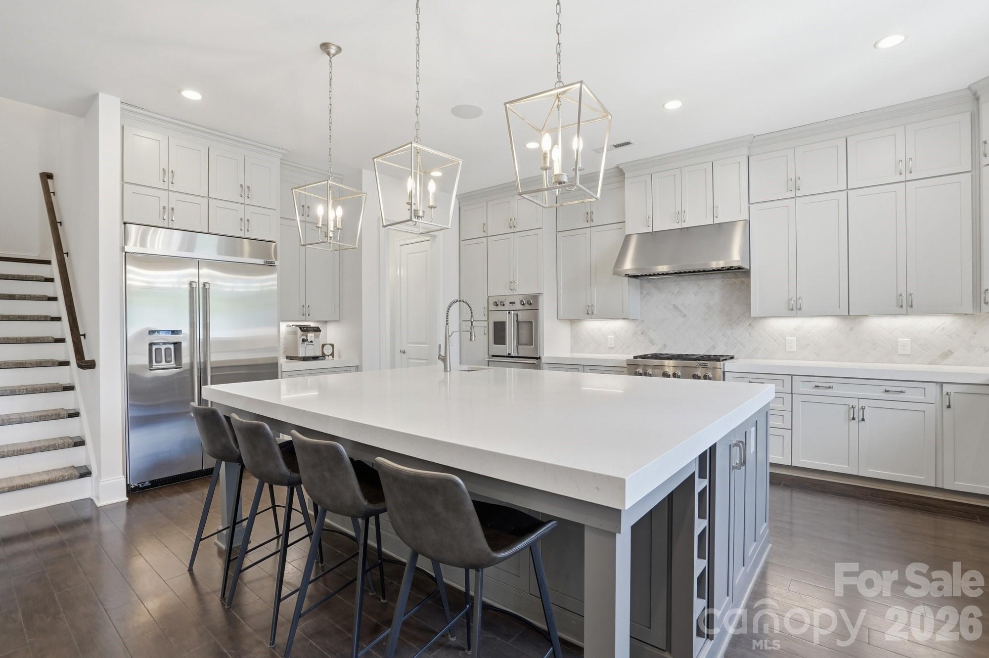 411 Turtleback Ridge Weddington, NC 28104 - Photo 15 of 48 a kitchen with granite countertop a table chairs stove a refrigerator and cabinets