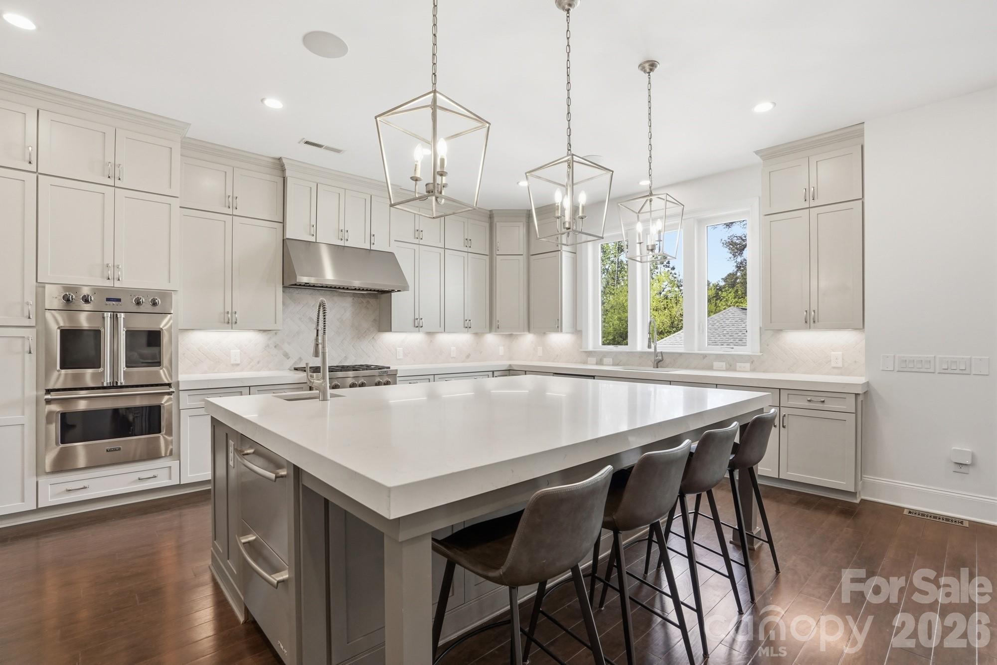411 Turtleback Ridge Weddington, NC 28104 - Photo 16 of 48 a kitchen with a table chairs stove and kitchen island